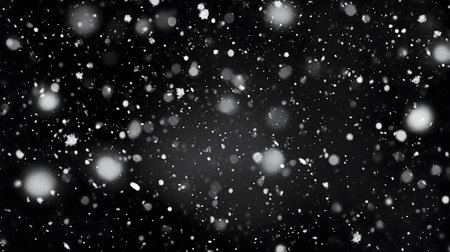 A mesmerizing image of snowflakes falling against a dark night sky.の写真素材