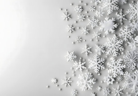 Elegant white snowflakes on a gray background. Perfect for winter or holiday designs.の写真素材