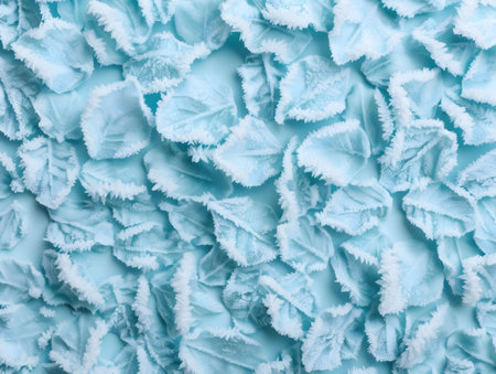 Close-up view of delicate light blue ice crystals, resembling frozen petals, creating a visually stunning and serene texture.の写真素材