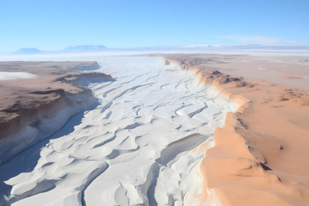 Stunning aerial shot of the Atacama Desert's unique geological formations. The contrasting colors and textures of sand dunes and canyons are breathtaking.の写真素材