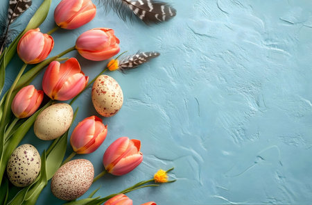 Pastel pink and orange tulips, speckled Easter eggs and feathers arranged artfully on a textured...
