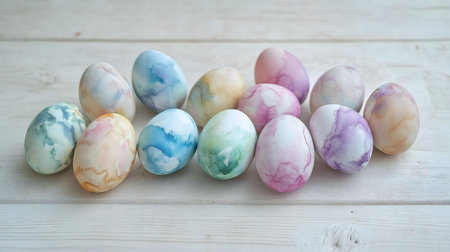 A collection of beautifully painted pastel Easter eggs arranged on a light wooden surface. Perfect...