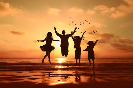 Silhouetted family joyfully jumping on a beach during a vibrant sunset. A heartwarming scene of family unity and summer fun.の写真素材