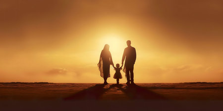 Silhouette of a family at sunset, holding hands on the beach. A beautiful moment of togetherness and love.の写真素材