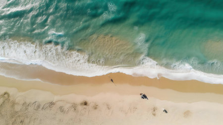 Stunning aerial shot of a pristine beach with clear turquoise water and gentle waves.の写真素材