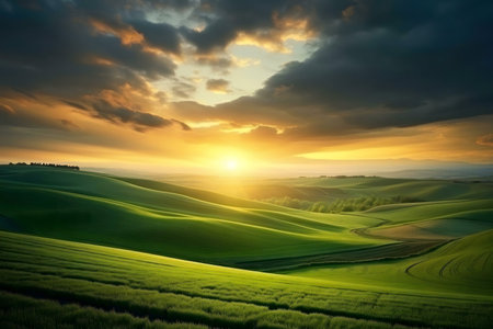 Serene sunset over rolling green hills. Peaceful, idyllic countryside landscape.の写真素材