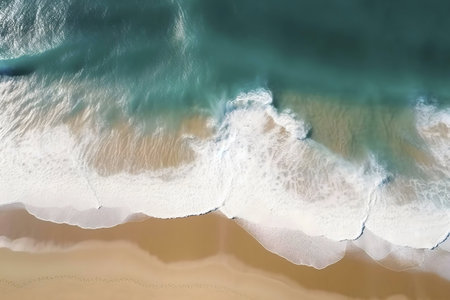 Stunning aerial shot of turquoise ocean waves breaking on a sandy beach. Peaceful and tranquil scene.の写真素材