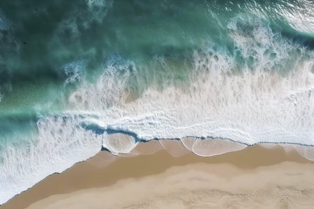 Stunning aerial shot of ocean waves breaking on a sandy beach. Turquoise water and white foam.の写真素材