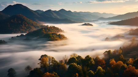 Misty sunrise over autumnal mountain range.の写真素材