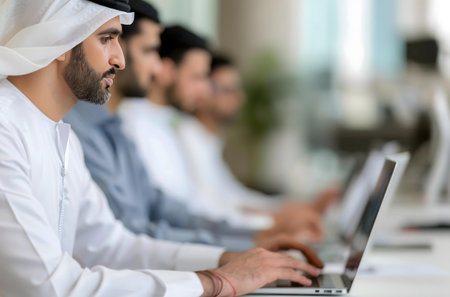 Arab businessmen in modern office using laptopsの写真素材