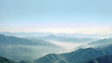 Majestic mountain range shrouded in morning mist. Serene and peaceful landscape.の写真素材