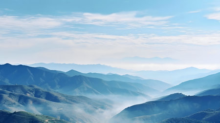 Serene mountain panorama. Misty blue hues dominate, creating a peaceful atmosphere.の写真素材