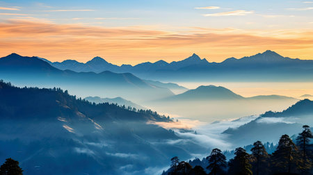 Sunrise paints the misty mountain range in hues of blue and gold.