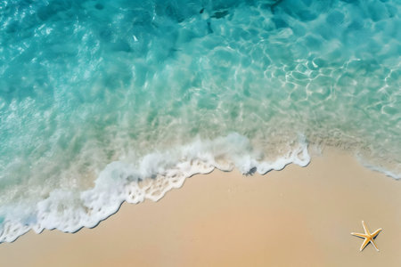A starfish rests on the golden sand as turquoise waves gently caress the shore. Idyllic beach scene.
