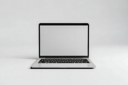 A sleek, modern laptop with a blank screen sits on a minimalist white background.の写真素材