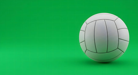 A white gaelic football rests on a vibrant green background, ready for action.の写真素材