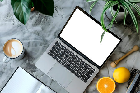 A flatlay image of a laptop, coffee, and citrus fruits on a gray desk. Perfect for blog or website.の写真素材