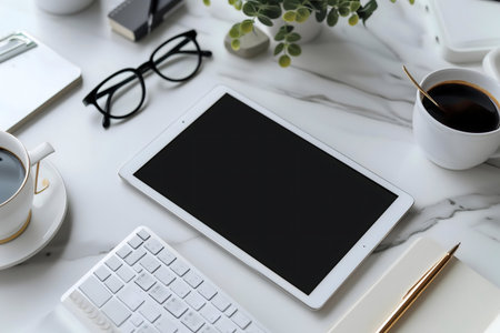 A clean, modern workspace featuring a tablet, keyboard, and coffee. Ideal for productivity and a calm atmosphere.の写真素材