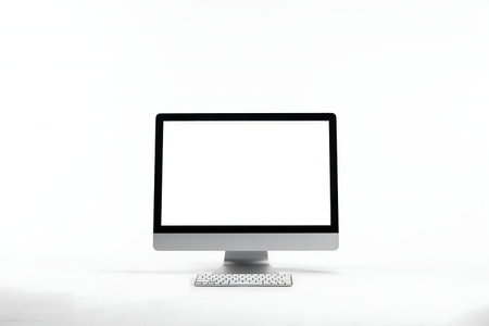A sleek desktop computer with a blank screen sits on a plain white background, ready for work or design.の写真素材