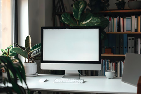 A clean, modern home office setup featuring plants and a calm atmosphere.の写真素材