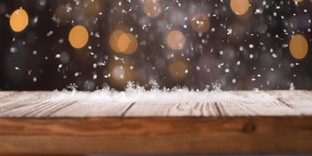 Snowy winter scene with falling snowflakes on wooden surface and blurry bokeh background