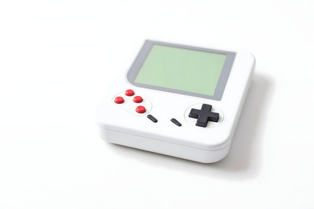 A nostalgic white handheld gaming console with red and black buttons, evoking memories of classic...