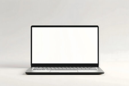 A sleek modern laptop with a blank white screen against a clean white background. Perfect for showcasing your design or app.の写真素材