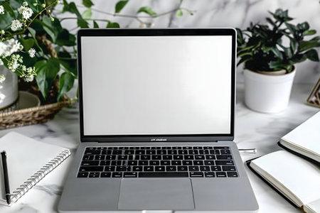 Clean minimalist workspace featuring a laptop, notebooks, and plants.