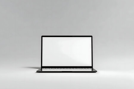A clean image of a black laptop with a white screen against a neutral background. Perfect for mockups.の写真素材