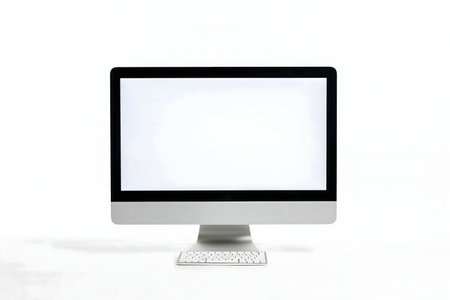 A sleek modern all-in-one desktop computer with a blank screen and keyboard on a white background.の写真素材