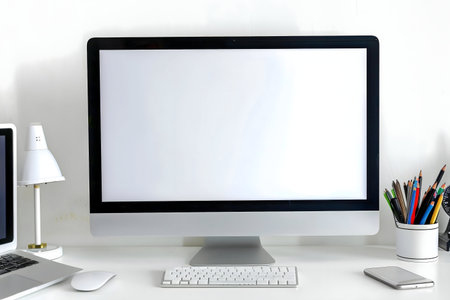 A minimalist workspace featuring a laptop, keyboard, mouse, and stationery. Clean and organized for...
