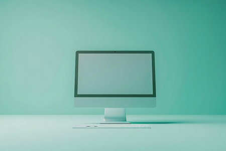 A clean, minimal image of a computer and keyboard on a teal background. Modern, stylish, and simple.の写真素材
