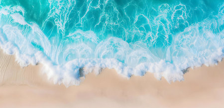Stunning aerial shot of turquoise waves meeting a pristine sandy beach. Peaceful and idyllic.