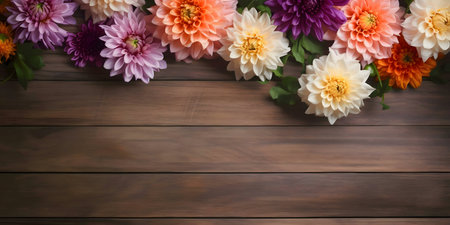 Colorful dahlias arranged on a rustic wooden background. A beautiful floral display.