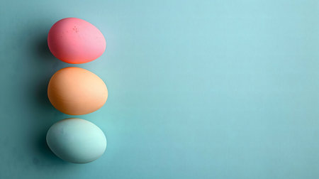 Three pastel colored eggs on a light blue background. Perfect for Easter.の写真素材