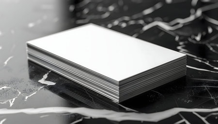 Stack of blank business cards on a marble surface. Perfect for showcasing your design.の写真素材