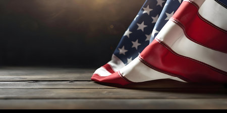 Close-up of an American flag draped on a rustic wooden surface.の写真素材