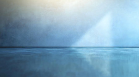 A minimalist image of a blue room. The smooth floor and wall create a serene atmosphere.の写真素材