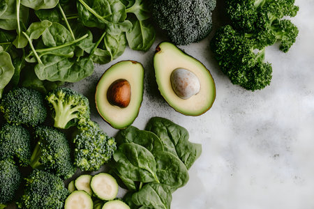 Close-up shot of assorted green vegetables including avocados, broccoli and spinach. A vibrant and healthy food image.の写真素材