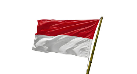 A vibrant Indonesian flag billows in the wind, its red and white colors bold against a clear...
