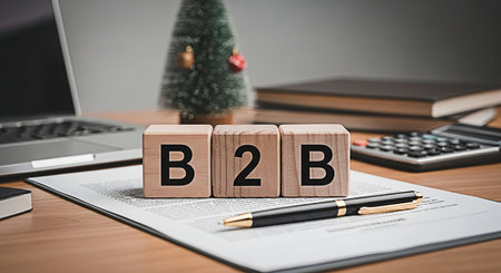 B2B - Business to Business acronym on wooden cubes with office background