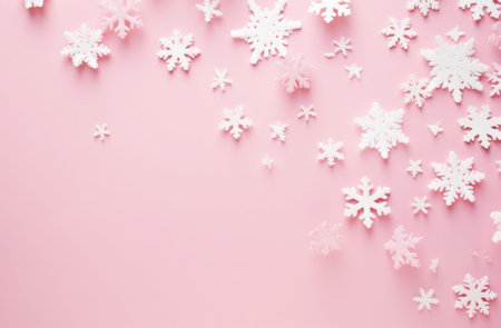 Christmas background. White snowflakes on pink background. Flat lay, top view, copy spaceの写真素材