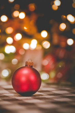 Christmas background with red ball and bokeh lights. Selective focus.の写真素材