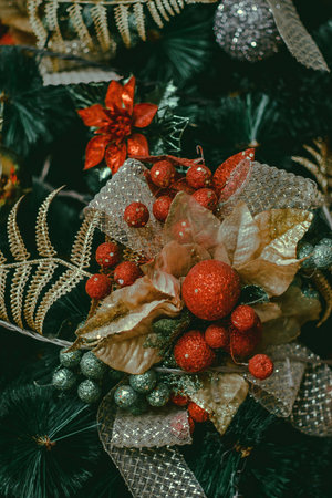 Christmas decoration with fir branches and red berries on dark background. Vintage toned