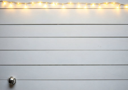Christmas lights on white wooden background with copy space for your text.の写真素材