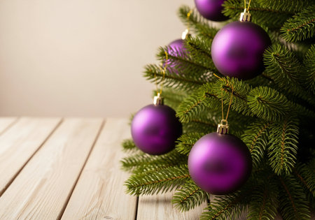Christmas tree with purple baubles on wooden table, closeupの写真素材