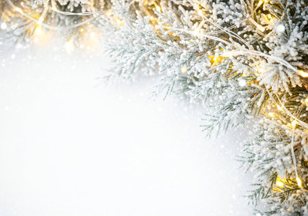 Christmas background with fir tree branches covered with snow and snowflakesの写真素材