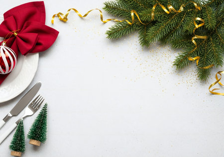 Christmas table setting with fir branches, cutlery and Christmas decorations on white backgroundの写真素材