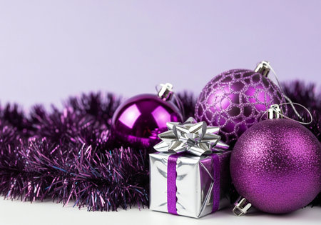 Purple christmas baubles and gift box on purple backgroundの写真素材