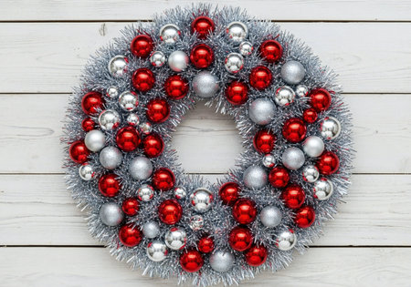 Christmas wreath with red and silver balls on a white wooden backgroundの写真素材